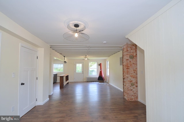 spare room with baseboards and wood finished floors