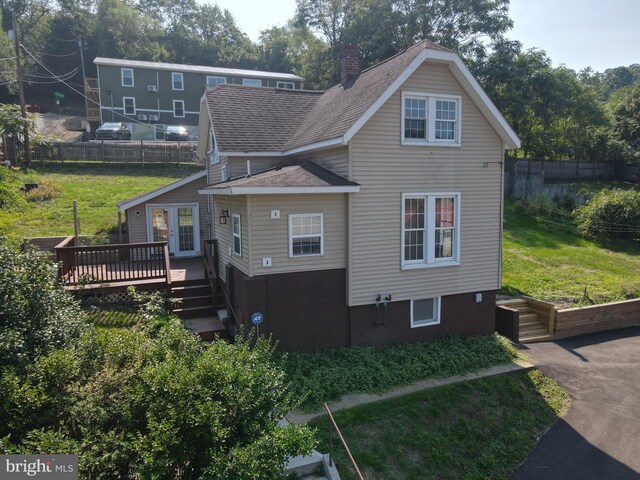 view of property exterior featuring a wooden deck