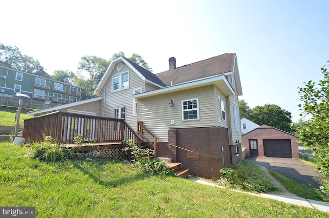 exterior space with a wooden deck, a garage, and an outdoor structure