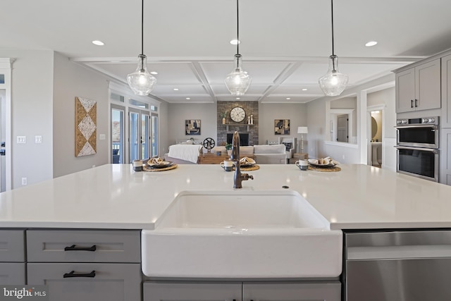 kitchen with open floor plan, stainless steel appliances, coffered ceiling, and gray cabinetry