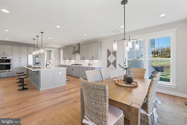 dining space with recessed lighting, baseboards, visible vents, and light wood finished floors