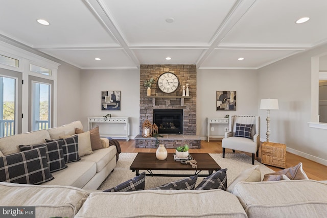 living room with coffered ceiling, a fireplace, baseboards, and wood finished floors