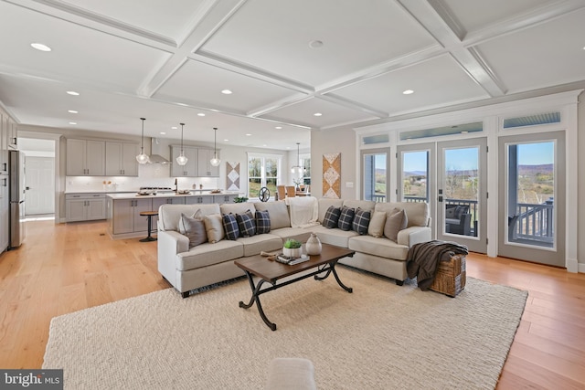 living area with light wood finished floors, beamed ceiling, coffered ceiling, and recessed lighting