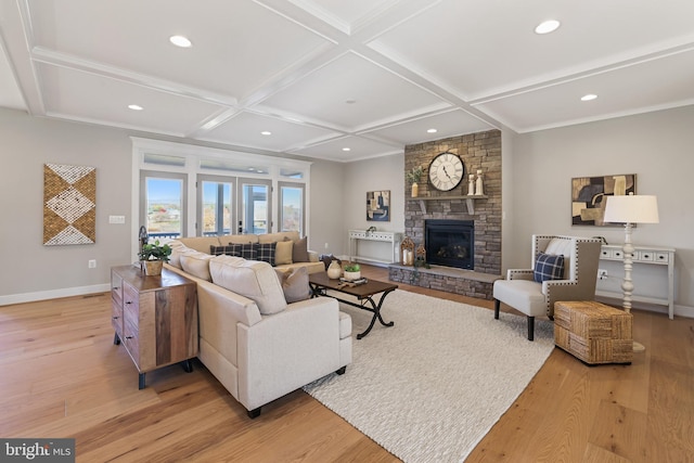 living area featuring light wood-type flooring, baseboards, and coffered ceiling