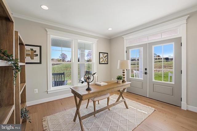 office area featuring light wood-style floors, baseboards, ornamental molding, and french doors