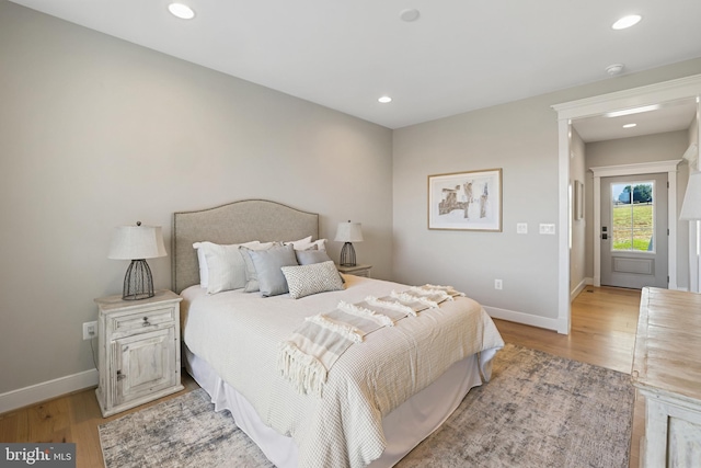 bedroom with recessed lighting, baseboards, and light wood finished floors