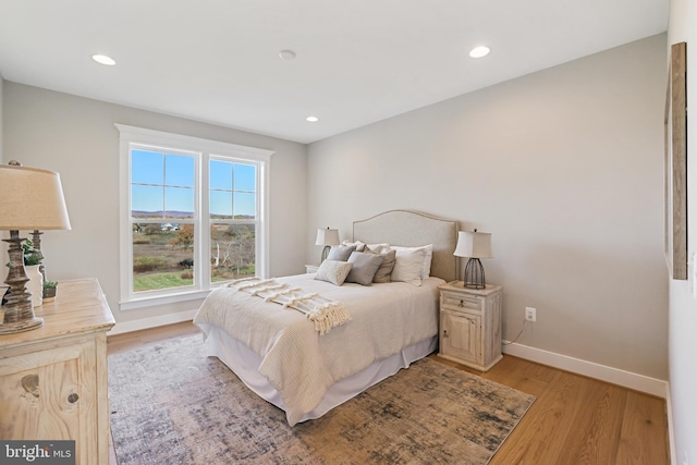 bedroom with recessed lighting, baseboards, and light wood finished floors