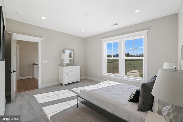 bedroom with recessed lighting, baseboards, visible vents, and light colored carpet