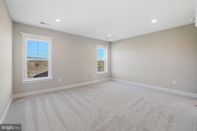 unfurnished room featuring baseboards, recessed lighting, visible vents, and light colored carpet