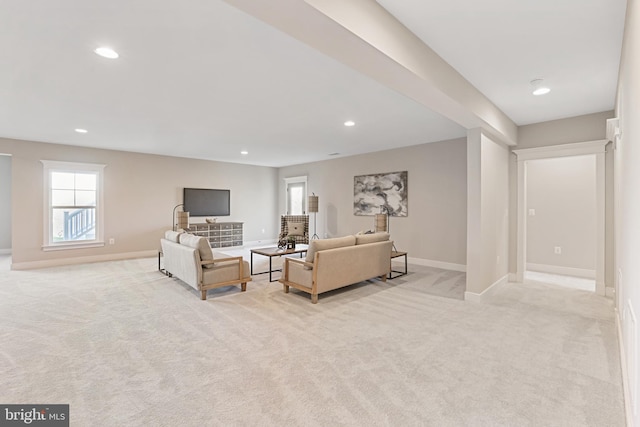 living area with light carpet, baseboards, and recessed lighting