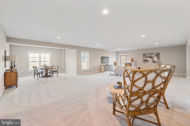 sitting room featuring light carpet, a wealth of natural light, and recessed lighting