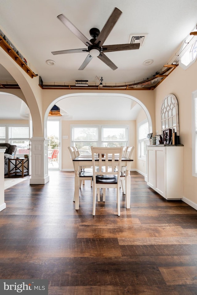 unfurnished dining area featuring ceiling fan and dark hardwood / wood-style flooring