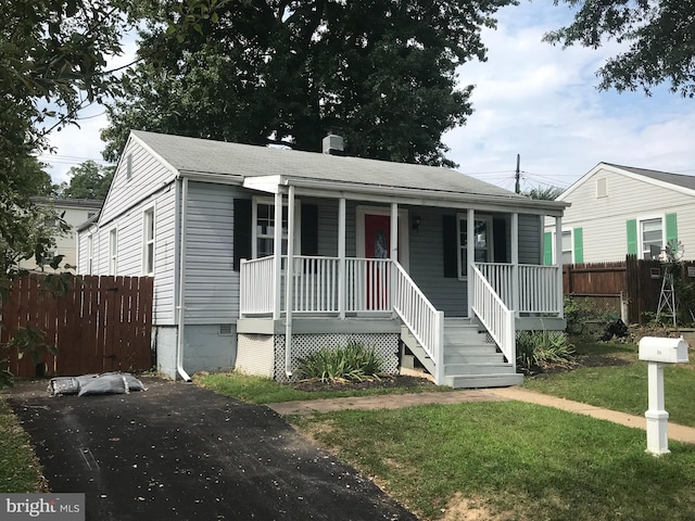 bungalow-style house with a front yard and a porch