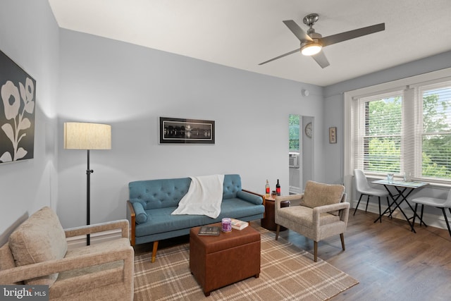 living room with hardwood / wood-style floors and ceiling fan