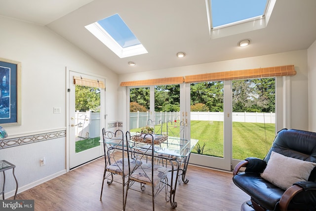 sunroom / solarium with vaulted ceiling with skylight and plenty of natural light