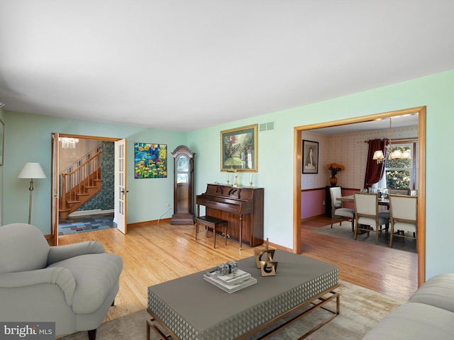 living room featuring a chandelier and light hardwood / wood-style floors