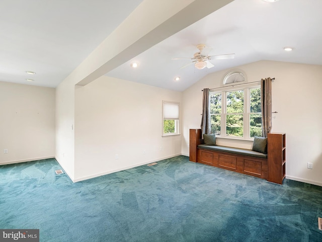 additional living space with lofted ceiling, ceiling fan, and dark colored carpet