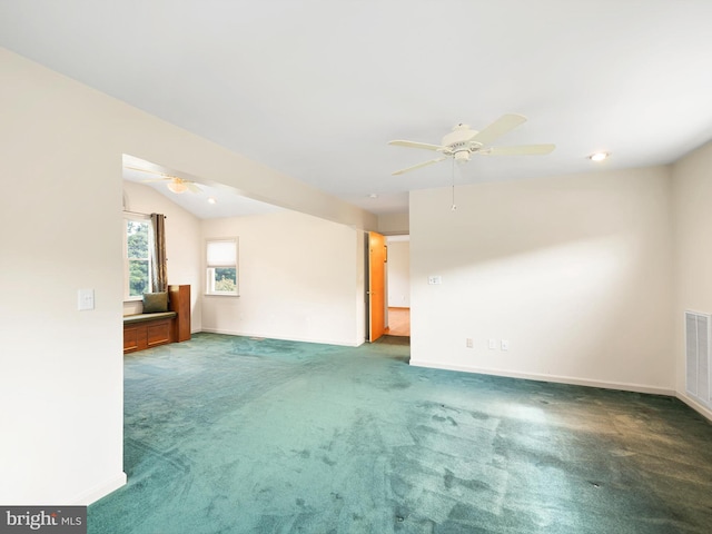 carpeted empty room featuring ceiling fan and vaulted ceiling