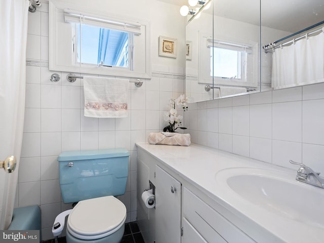 full bathroom featuring tile walls, toilet, shower / tub combo with curtain, and vanity