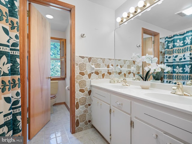 bathroom with vanity, toilet, and tile patterned floors