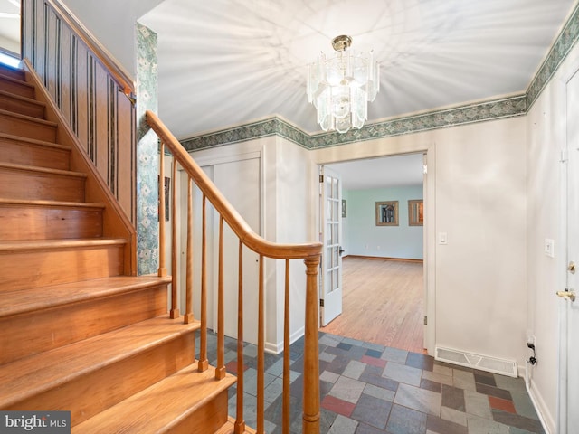 interior space with tile patterned flooring and a notable chandelier