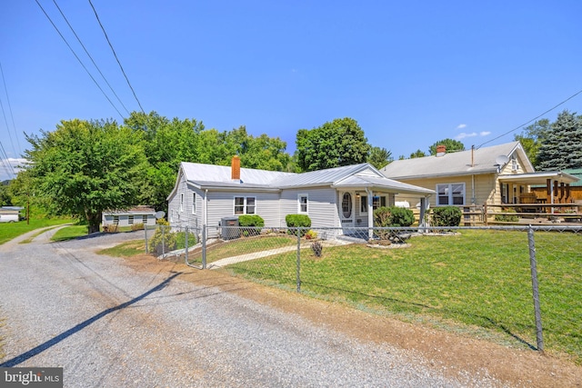 view of front of house featuring covered porch and a front yard