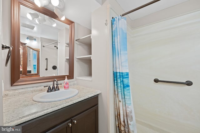 full bath featuring a shower with curtain, visible vents, and vanity