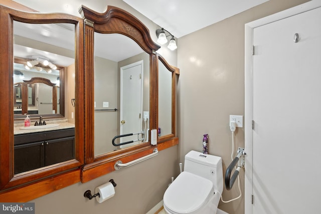 bathroom featuring toilet and vanity