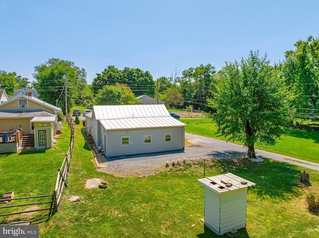 exterior space featuring gravel driveway and fence