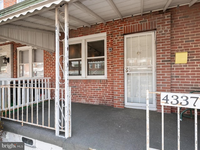 entrance to property featuring brick siding