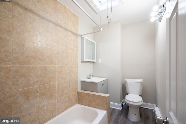 bathroom featuring shower / bath combination, toilet, vanity, wood finished floors, and baseboards