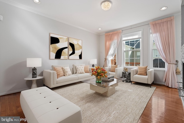 living room with hardwood / wood-style flooring and crown molding