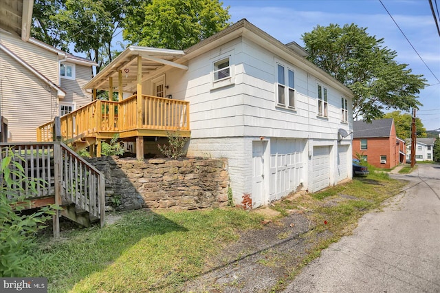 exterior space featuring a garage and a deck