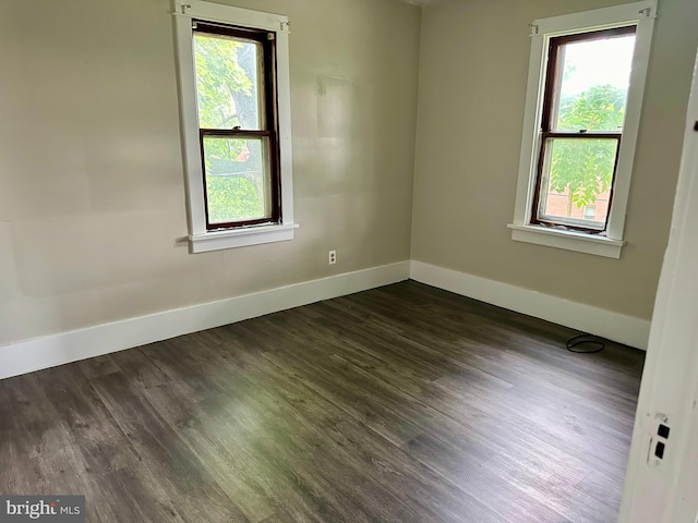 empty room with dark hardwood / wood-style floors