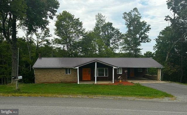 ranch-style home with a front yard and a carport