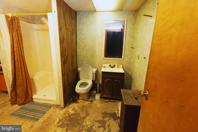 bathroom featuring a stall shower, vanity, and toilet