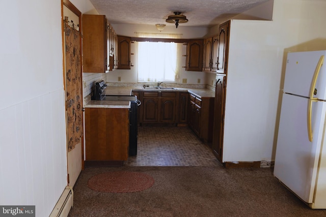 kitchen with white refrigerator, sink, black electric range oven, and a textured ceiling