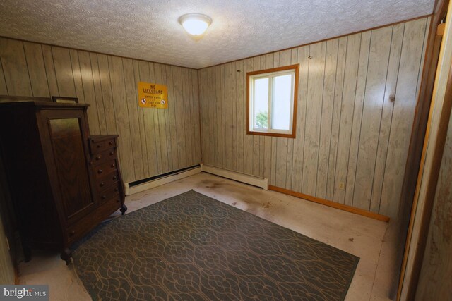 spare room with a textured ceiling and baseboards