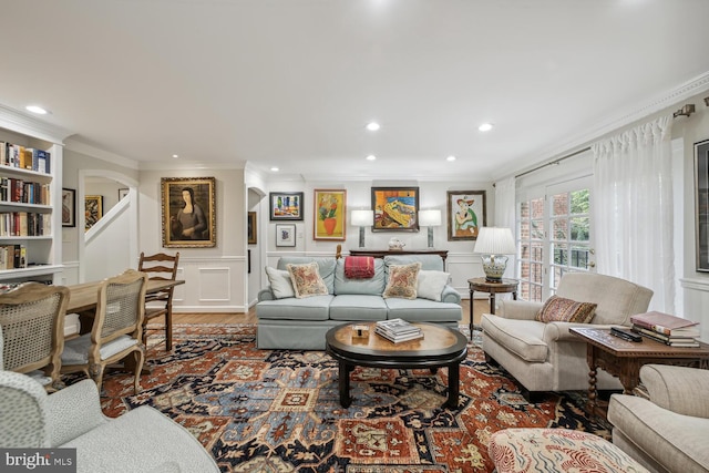 living room featuring hardwood / wood-style floors and crown molding