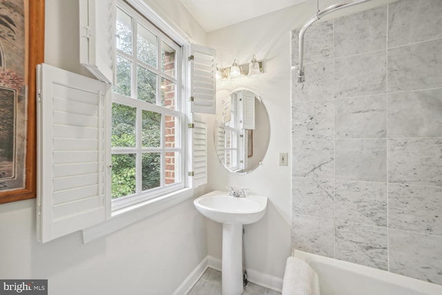 bathroom with a bathtub, a wealth of natural light, and tile patterned floors