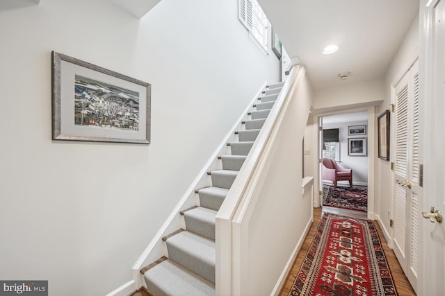 stairs featuring hardwood / wood-style flooring