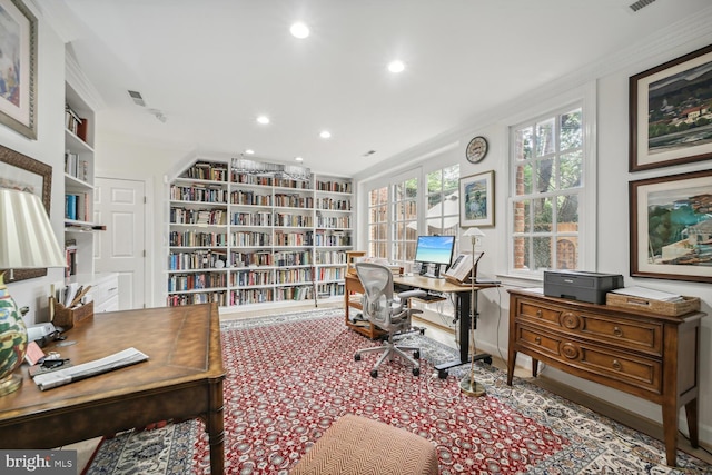 home office with built in shelves and crown molding