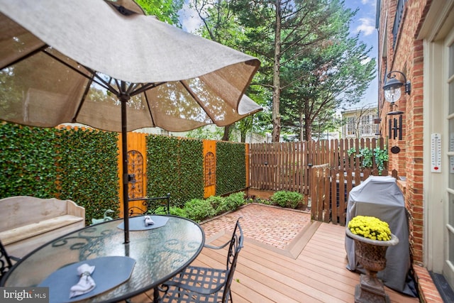 wooden terrace featuring area for grilling