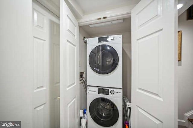 washroom featuring stacked washer / dryer