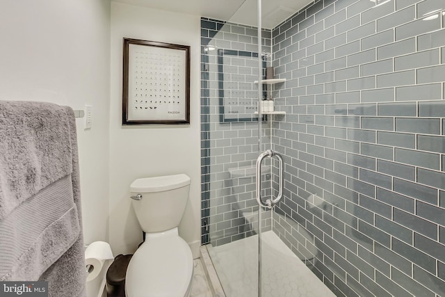 bathroom with a shower stall and toilet