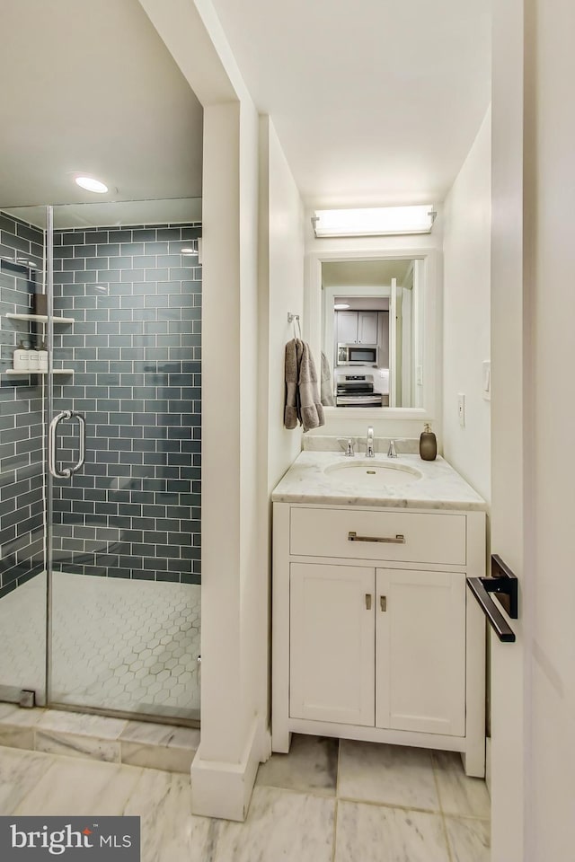 bathroom featuring a stall shower and vanity