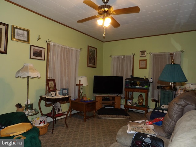 carpeted living room featuring ceiling fan and ornamental molding