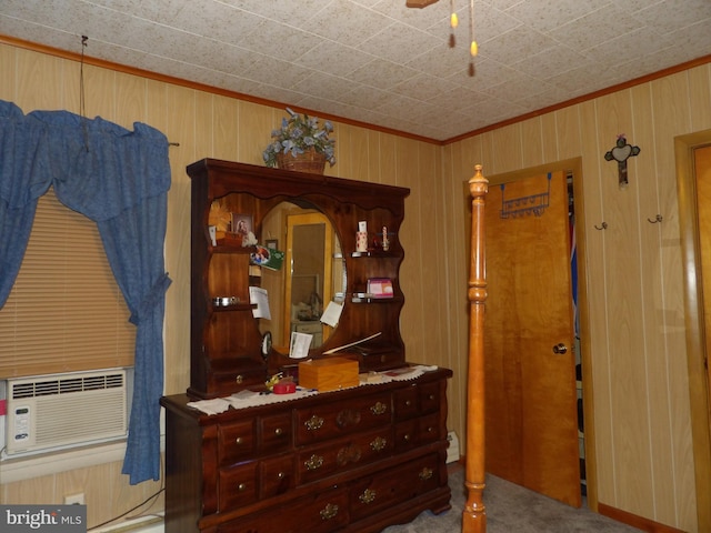 carpeted bedroom featuring cooling unit and wooden walls