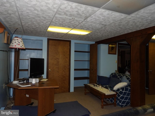 carpeted office space featuring a paneled ceiling