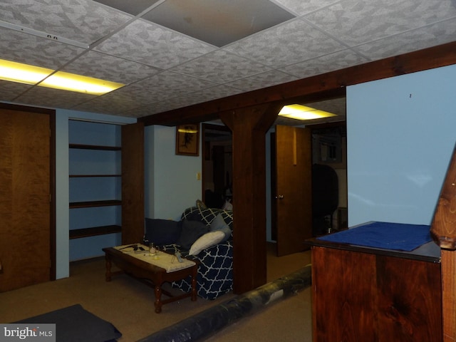 basement with carpet and a paneled ceiling